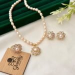 Pink freshwater pearl necklace set with floral pendant, matching floral earrings and adjustable ring by Glamify