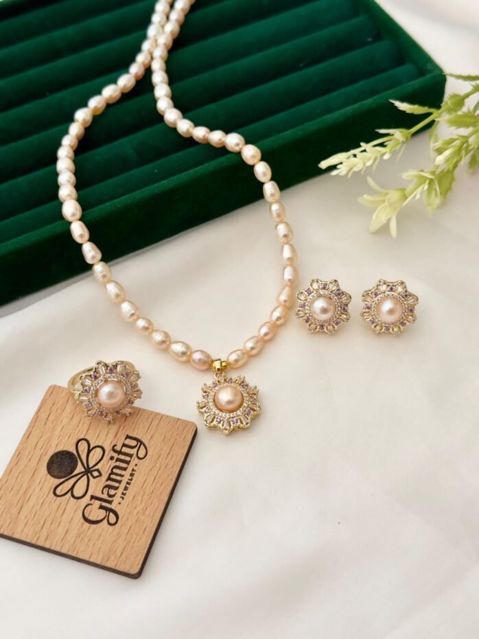 Pink freshwater pearl necklace set with floral pendant, matching floral earrings and adjustable ring by Glamify