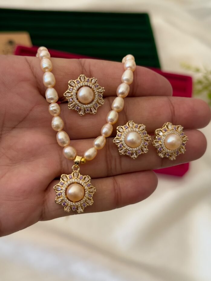 Pink freshwater pearl necklace set with floral pendant, matching floral earrings and adjustable ring by Glamify