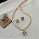 Pink freshwater pearl necklace set with square stone-detailed pendant, matching earrings and adjustable ring by Glamify