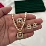 Pink freshwater pearl necklace set with square stone-detailed pendant, matching earrings and adjustable ring by Glamify